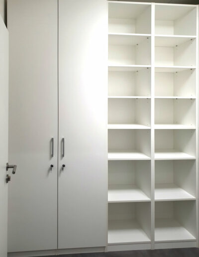 Pantová skříň s otevřenými policemi v bílé barvě.